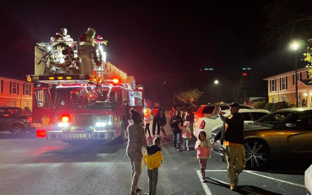 Santa makes his way through neighborhoods on fire truck
